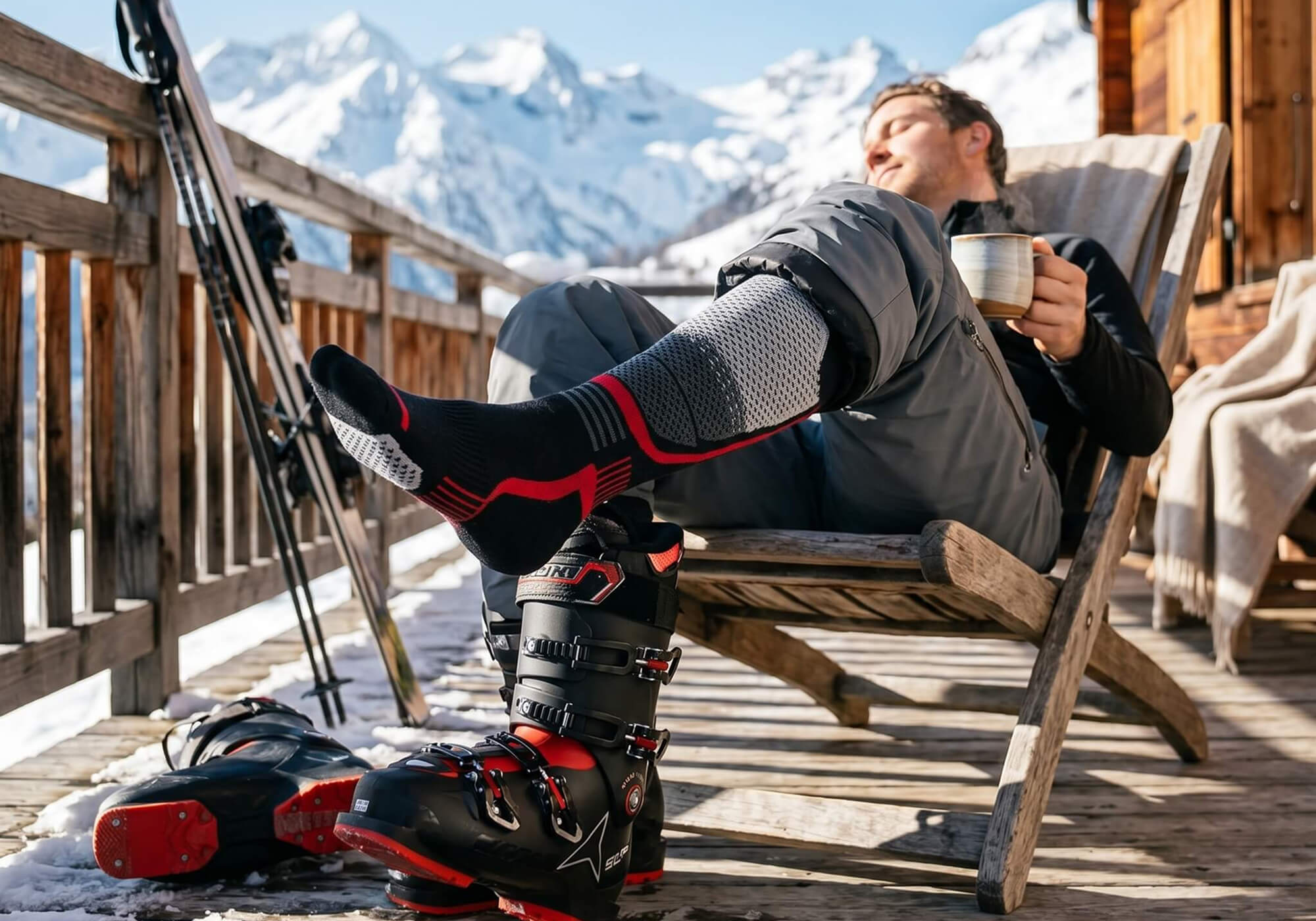 Mann trägt seine Alpaka Skisocken und genießt den Apres Ski Moment